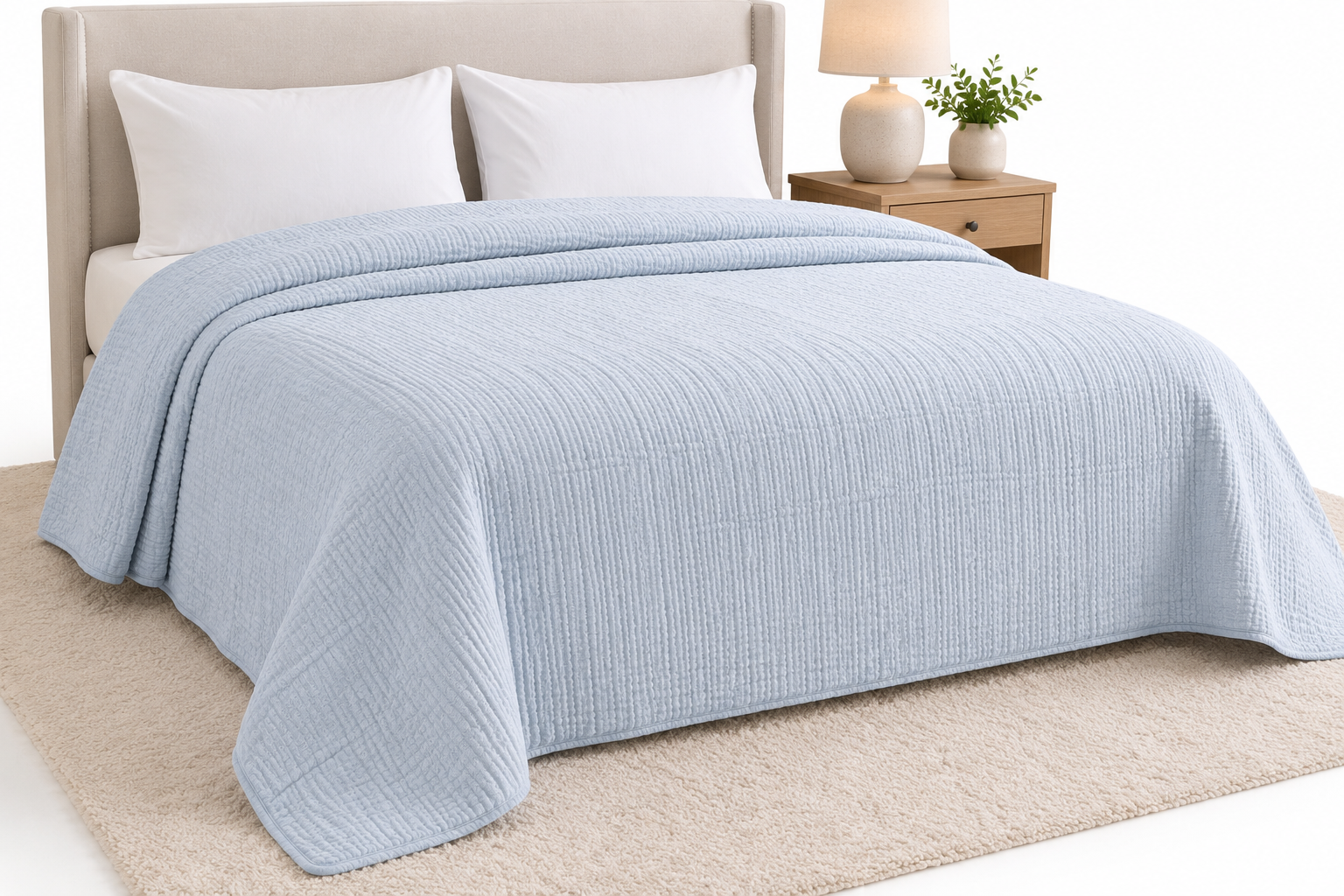Soft blue muslin bedspread styled on modern bed